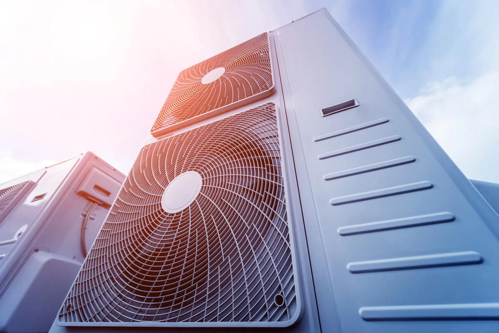 Outdoor AC unit under bright sunlight