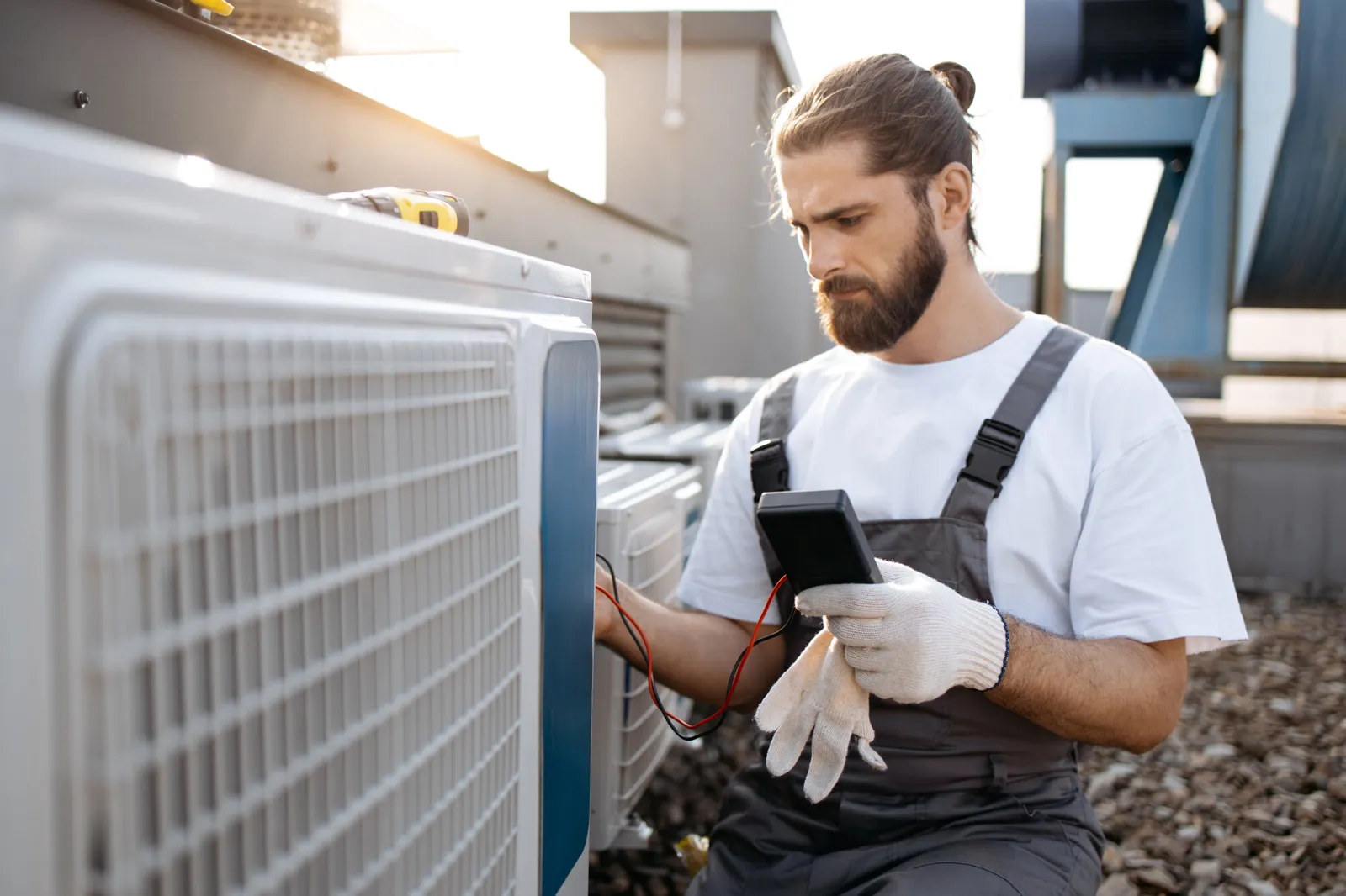 Technician checking an outdoor AC unit at a residence